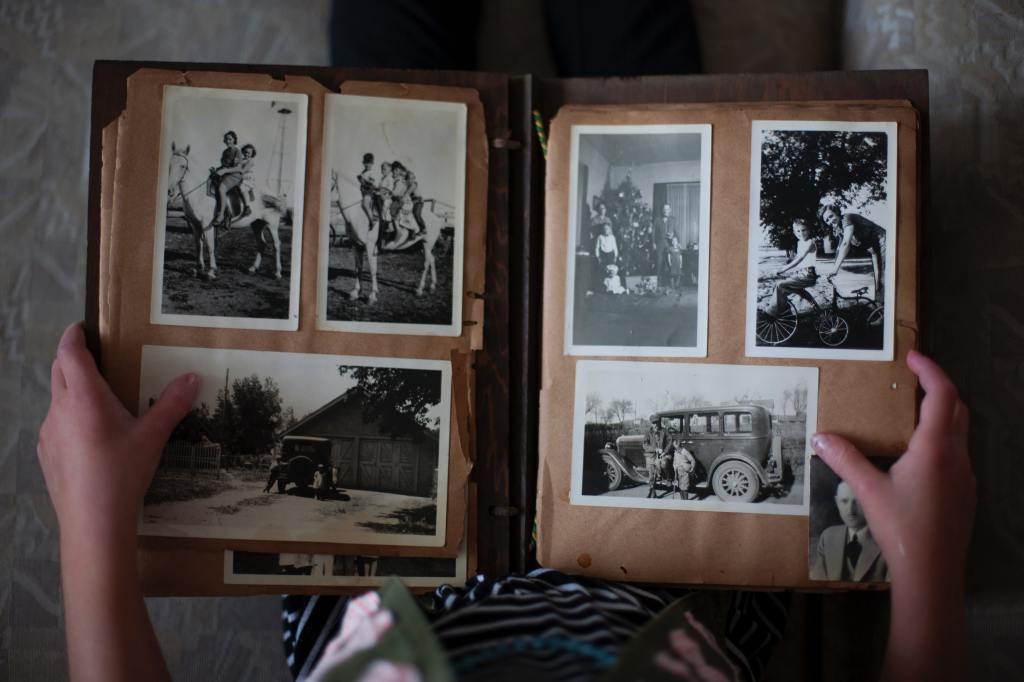Image of vintage photo album being held in two hands. 